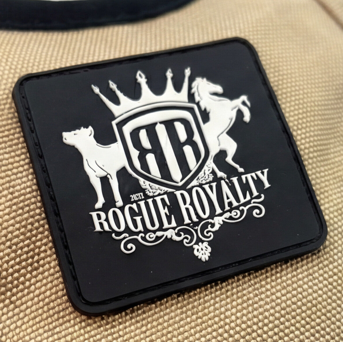 Patch with 'Rogue Royalty' design on a beige fabric dog harness padded chest support