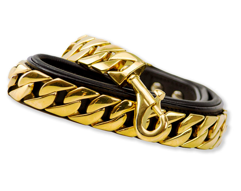 A gold chain bracelet featuring a stylish black leather buckle, combining elegance and modern design in one accessory.